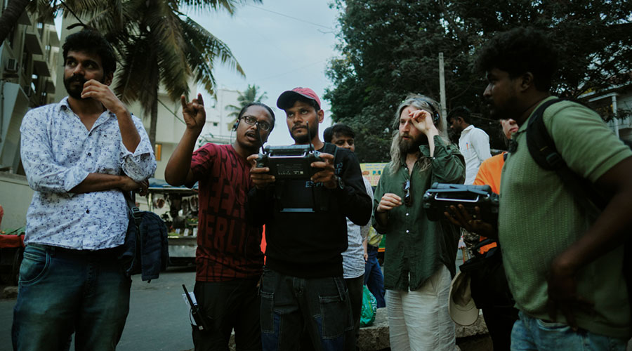 Film crew stands together and consults