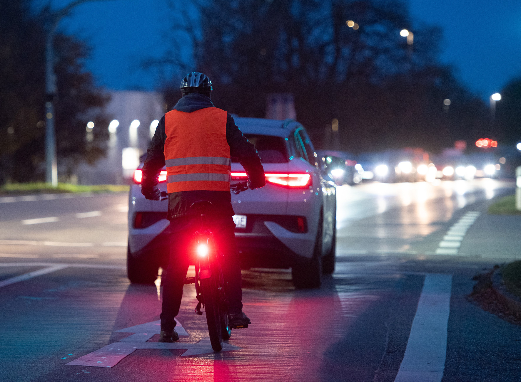 Fahrradfahrer mit Warnweste im Dunkeln