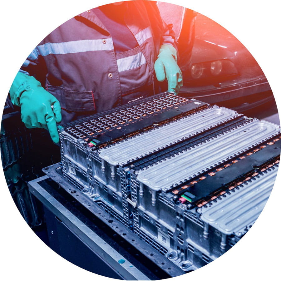 Image of a person working on batteries of an electric vehicle.