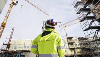 Experto en control técnico en obra mirando edificios
