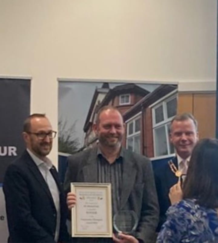 Mick Salt holding a certificate next to the mayor