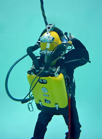 diver underwater with diving rebreather rear view