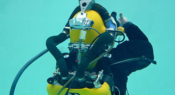 rear view of diver underwater with diving rebreather