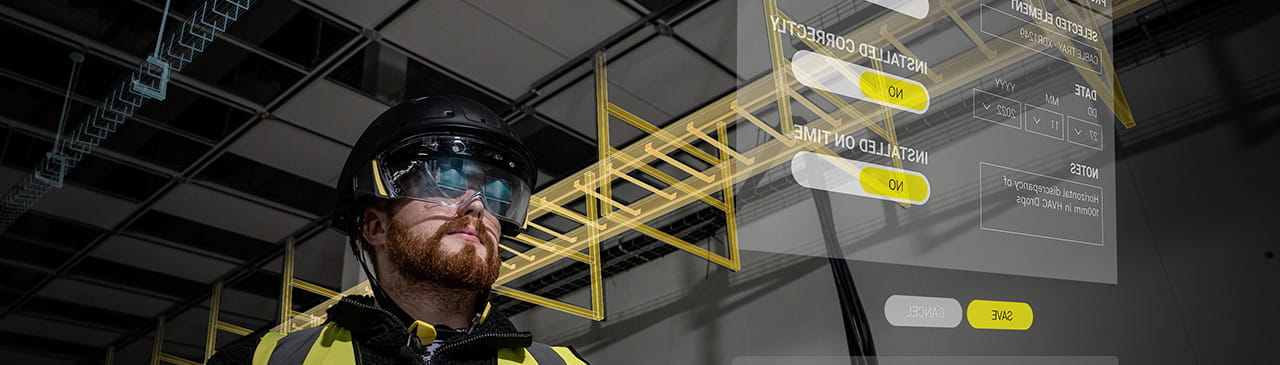 Man wearing AR Helmet for Construction Industry pointing at screen
