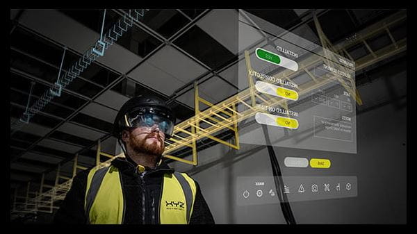 Man wearing AR Helmet for Construction Industry pointing at screen